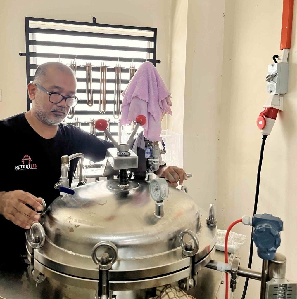 instruktor sedang menggunakan mesin retort makanan 100 liter